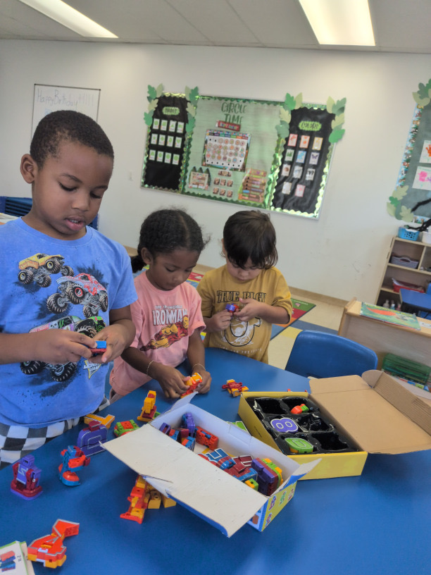 Children building with colorful construction toys at a table