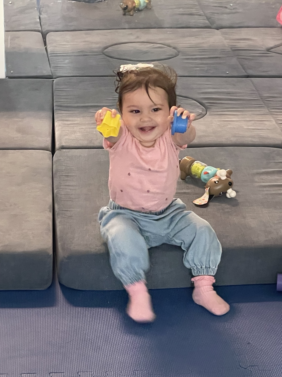 A child exploring colorful toys